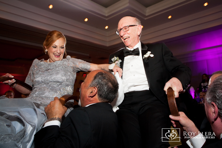 Parents raised above the celebration during the Hora